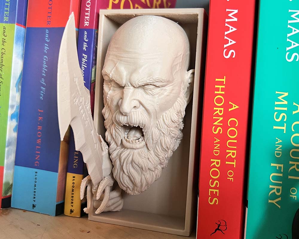 Side view of Kratos book nook with raised axe and sculpted armour