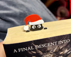 Christmas peeping cat book bookmark inside the book, cat wearing a santa hat bookmark for book lovers and cat lovers stocking fillers