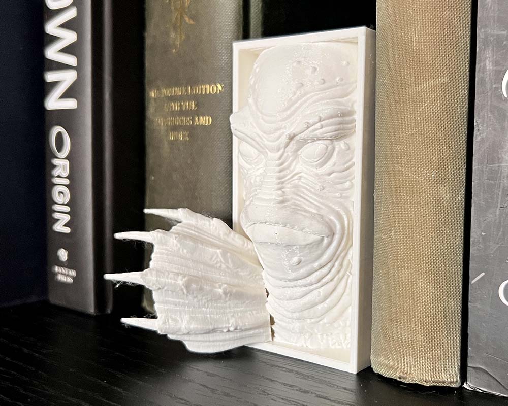 Horror-fantasy bookshelf insert with swamp creature design