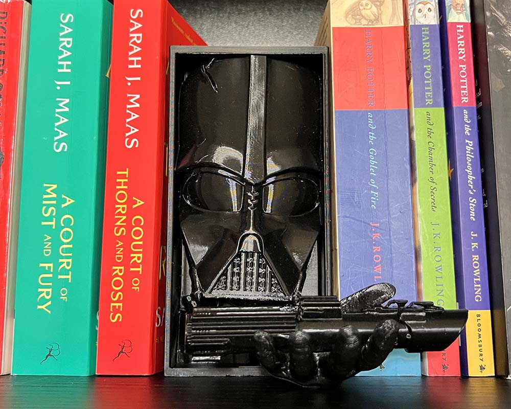 Darth Vader book nook with lightsaber in hand 3D printed Star Wars shelf insert featuring Darth Vader Sith Lord bookshelf décor with lightsaber detail Dark Side Darth Vader book nook gift for Star Wars fans Cinematic book nook insert Darth Vader holding lightsaber