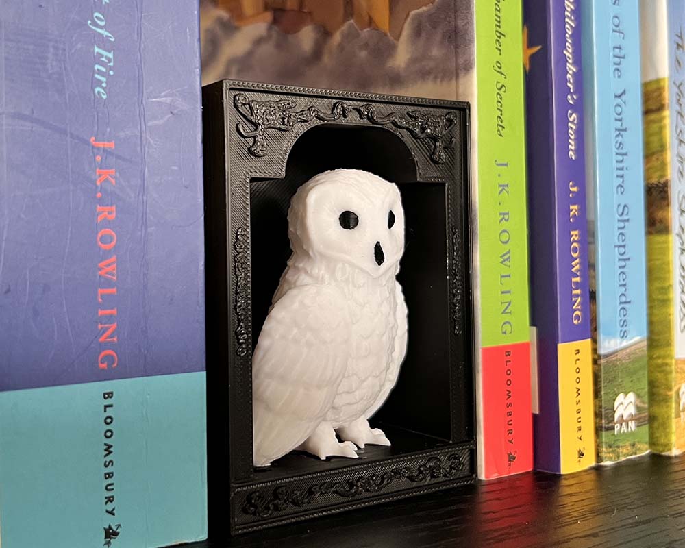 Decorative book nook featuring Hedwig the owl