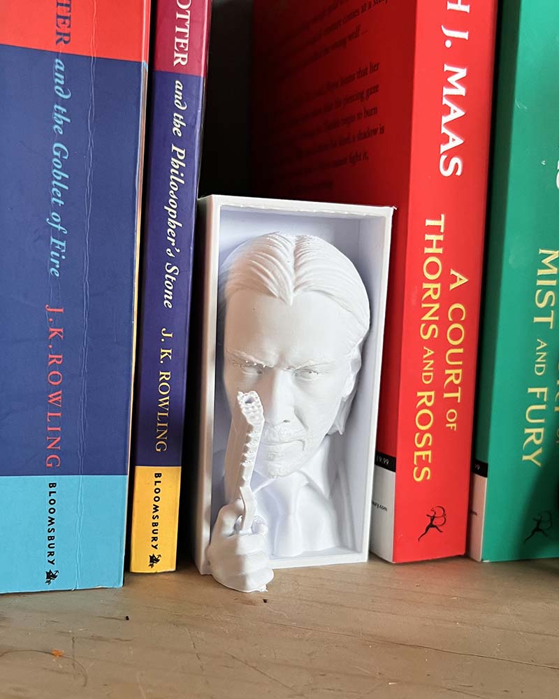 3D printed movie shelf insert with intense action film vibe