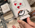 pokemon pokeball trolley coin being inserted into a trolley