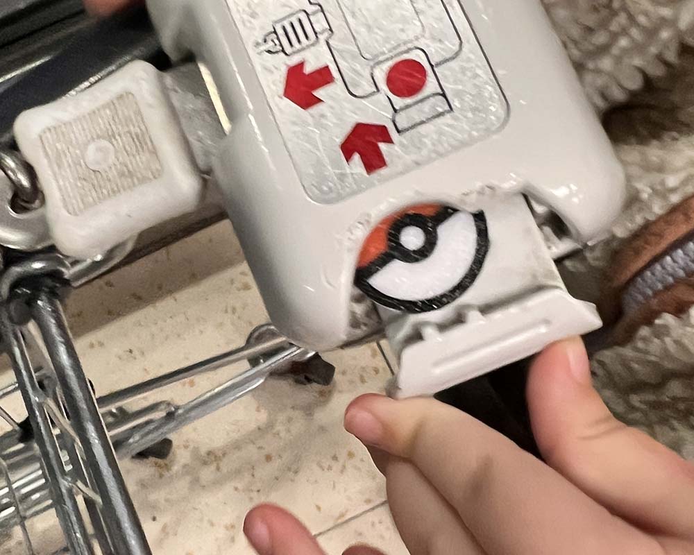 pokemon pokeball trolley coin being inserted into a trolley