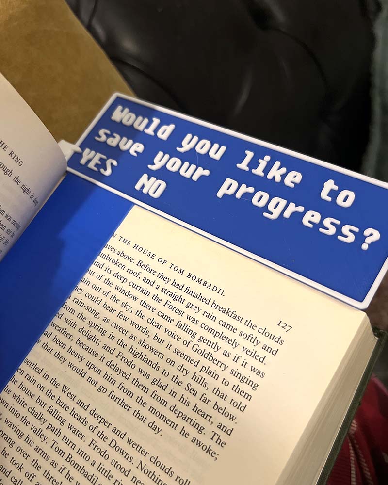 Book with a blue sign asking 'Would you like to save your progress?'