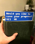 Fallout-inspired save progress bookmark in blue 3D printed gamer bookmark styled after Fallout save icon Blue save symbol book accessory for Fallout fans
