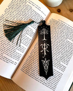 Fantasy bookmark with green tassel laid on open Lord of the Rings book in black and white coloured filament 3d printed