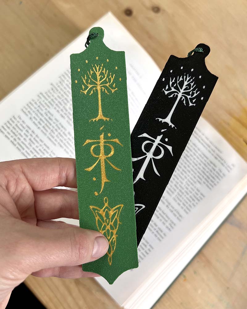Hand holding Tolkien bookmark for scale and slimness